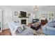 Bright living room with a fireplace, TV, and neutral color palette at 1039 S Philwood Ct, Fuquay Varina, NC 27526