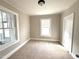 Neutral-toned bedroom with carpet, windows, and white trim throughout at 111 113 Highland Ave, Burlington, NC 27217