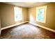 A cozy bedroom features plush carpeting, neutral paint, and natural light from the window at 111 113 Highland Ave, Burlington, NC 27217