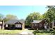 Brick homes with well maintained lawns and mature shade trees on a sunny day at 111 113 Highland Ave, Burlington, NC 27217