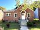 Charming brick home featuring a classic design, well-maintained lawn, and welcoming front entrance at 111 113 Highland Ave, Burlington, NC 27217
