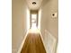 Bright hallway with light wood flooring leading to rooms with white trim doorways at 111 113 Highland Ave, Burlington, NC 27217
