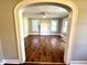 Inviting living room featuring a ceiling fan, wood floors and bright natural light from the windows at 111 113 Highland Ave, Burlington, NC 27217
