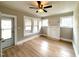 Inviting living room featuring light colored walls, wood floors and bright natural light from the windows at 111 113 Highland Ave, Burlington, NC 27217