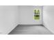 Minimalist bedroom with neutral carpeting and a single window overlooking the backyard at 1140 Sun Springs Rd, Wake Forest, NC 27587