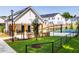 Community area with an outdoor kitchen and basketball court amid green lawns and modern homes at 1140 Sun Springs Rd, Wake Forest, NC 27587