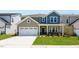 Charming two-story home with a two-car garage, well-manicured lawn, and inviting front porch at 1140 Sun Springs Rd, Wake Forest, NC 27587