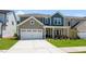 Charming home exterior featuring a well-maintained lawn and a driveway at 1140 Sun Springs Rd, Wake Forest, NC 27587