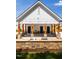 Outdoor grilling station featuring a white exterior, wooden pillars, and a built-in grill at 1140 Sun Springs Rd, Wake Forest, NC 27587