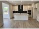 Well-equipped kitchen with stainless steel appliances, white cabinets, island, and a modern backsplash at 1140 Sun Springs Rd, Wake Forest, NC 27587