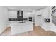 Modern white kitchen with a large island, stainless steel appliances, and stylish backsplash at 1140 Sun Springs Rd, Wake Forest, NC 27587