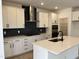 Modern kitchen featuring white cabinets, sleek countertops, stainless steel appliances, and a stylish backsplash at 1140 Sun Springs Rd, Wake Forest, NC 27587