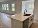 Kitchen island with stainless steel dishwasher, sleek faucet and sink, quartz countertops, and modern white cabinets at 1140 Sun Springs Rd, Wake Forest, NC 27587
