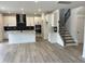 Bright and spacious living area connected to the staircase and kitchen, featuring hardwood floors and ample natural light at 1140 Sun Springs Rd, Wake Forest, NC 27587