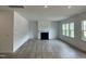 Spacious living room featuring a fireplace, hardwood floors, recessed lights and ample natural light from large windows at 1140 Sun Springs Rd, Wake Forest, NC 27587