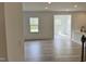 Bright living room showcasing hardwood floors and expansive windows, offering a light-filled and inviting space at 1140 Sun Springs Rd, Wake Forest, NC 27587