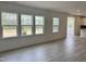 Bright, open-concept living space boasting hardwood floors, large windows, and seamless flow into the modern kitchen at 1140 Sun Springs Rd, Wake Forest, NC 27587