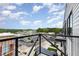 Balcony with view overlooking a parking lot, retail area, and green landscape at 120 Mosaic Blvd # 308, Pittsboro, NC 27312
