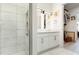 Bright bathroom with tiled shower, double vanity, and well-organized closet at 120 Mosaic Blvd # 308, Pittsboro, NC 27312