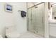 Bathroom featuring a tiled shower, a toilet, and marble tile flooring at 120 Mosaic Blvd # 308, Pittsboro, NC 27312
