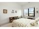 Bright bedroom with large window, side chair, and view of surrounding landscape at 120 Mosaic Blvd # 308, Pittsboro, NC 27312