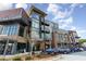 Modern building exterior with a mix of brick, wood, and glass, plus ample parking and manicured landscaping at 120 Mosaic Blvd # 308, Pittsboro, NC 27312