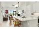 Bright open kitchen with modern lighting, white cabinetry, and views to the living area at 120 Mosaic Blvd # 308, Pittsboro, NC 27312