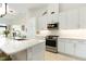 Bright, modern kitchen with stainless steel appliances, quartz countertops, and ample cabinet space at 120 Mosaic Blvd # 308, Pittsboro, NC 27312