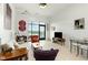 Bright living room featuring large windows with a view, modern decor, and light wood flooring at 120 Mosaic Blvd # 308, Pittsboro, NC 27312