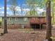 Exterior view of the home featuring a spacious deck and lush green lawn at 122 Monticello Ave, Durham, NC 27707