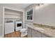 Well-lit bathroom featuring a modern vanity, granite countertops, and a laundry area for added convenience at 122 Monticello Ave, Durham, NC 27707