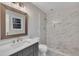 Bright bathroom featuring a sleek vanity, modern fixtures, and a walk-in shower at 122 Monticello Ave, Durham, NC 27707