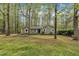 Charming single-story home with manicured lawn and mature trees in the front yard at 122 Monticello Ave, Durham, NC 27707