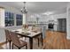 Modern kitchen with stainless steel appliances adjacent to an elegant dining area with natural light at 122 Monticello Ave, Durham, NC 27707