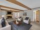 Cozy living room with exposed wood beams, a stone fireplace, and comfortable seating, perfect for relaxation at 122 Monticello Ave, Durham, NC 27707