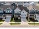 Aerial shot of a light blue two-story home in a suburban neighborhood with well-kept lawns at 1237 Porters Call Dr, Wendell, NC 27591