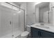 Modern bathroom featuring a glass-enclosed shower, toilet, and sleek vanity with a large mirror at 1237 Porters Call Dr, Wendell, NC 27591