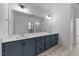 Bathroom features a double sink vanity, large mirror, and designer tile floors at 1237 Porters Call Dr, Wendell, NC 27591