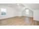Spacious bedroom with vaulted ceiling, bright white walls, and light wood floors at 1237 Porters Call Dr, Wendell, NC 27591