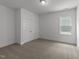 Bedroom features neutral carpet, a window, and a double-door closet at 1237 Porters Call Dr, Wendell, NC 27591