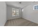 Serene bedroom with neutral carpet, white walls, and multiple windows for ample natural light at 1237 Porters Call Dr, Wendell, NC 27591