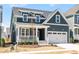 Charming two-story home with a well-manicured lawn and inviting front porch and a two car garage at 1237 Porters Call Dr, Wendell, NC 27591