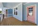 Charming front porch with a light blue ceiling and walls, featuring a stylish pink front door at 1237 Porters Call Dr, Wendell, NC 27591
