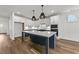 Bright kitchen showcases a large island, modern lighting fixtures, and stainless steel appliances at 1237 Porters Call Dr, Wendell, NC 27591