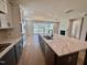 Kitchen with stainless appliances, stone countertops and large sliding doors leading into the living room at 1237 Porters Call Dr, Wendell, NC 27591