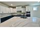 Kitchen featuring white and navy cabinets, stone countertops and stainless steel appliances at 1237 Porters Call Dr, Wendell, NC 27591