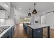 Open kitchen with an island, stainless steel appliances, pendant lighting, and an adjacent living space at 1237 Porters Call Dr, Wendell, NC 27591