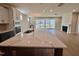 Kitchen with stainless appliances, stone countertops and large sliding doors leading into the living room at 1237 Porters Call Dr, Wendell, NC 27591