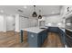 Large kitchen boasts a center island, pendant lighting, stainless steel appliances, and stylish flooring at 1237 Porters Call Dr, Wendell, NC 27591