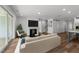 Comfortable living room with modern decor, fireplace, and large windows for natural light at 1237 Porters Call Dr, Wendell, NC 27591